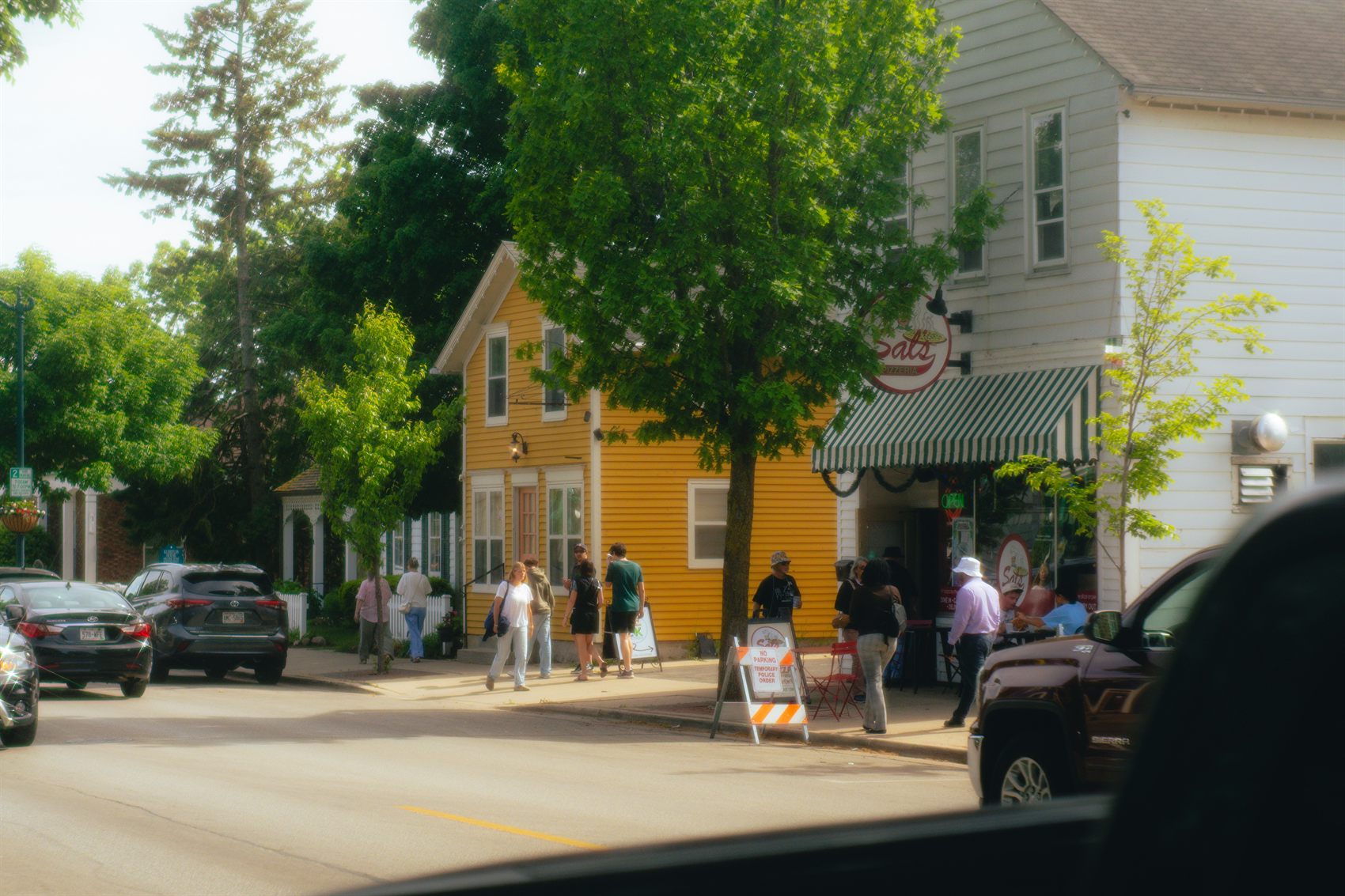 Shoppers gathered outside a local storefront on a small-town main street